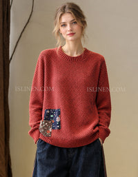 Women’s red textured knit sweater with patchwork detail, front view