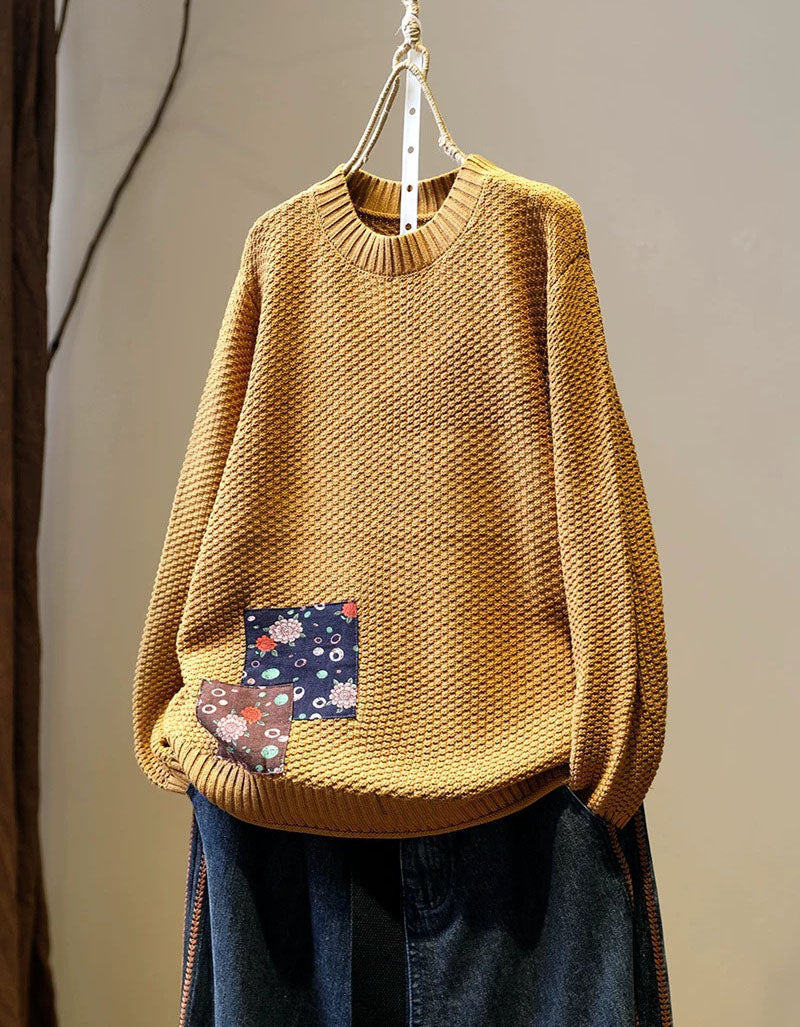 Women’s yellow long sleeve knit pullover styled with dark denim jeans