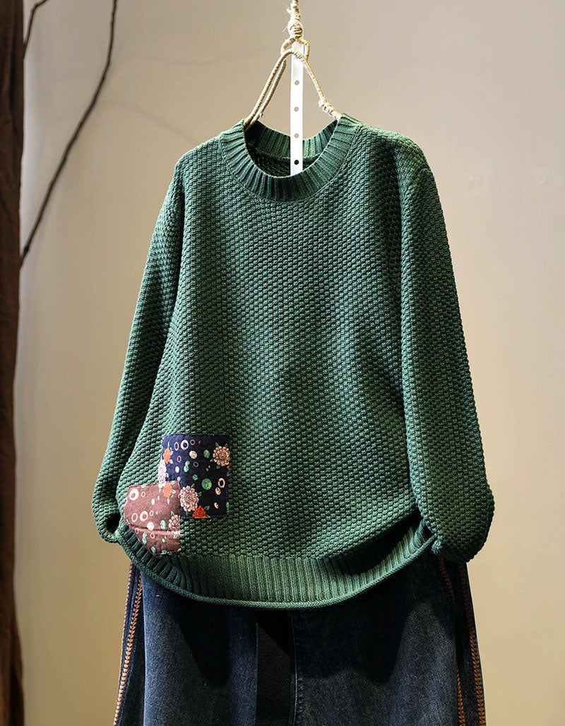 Women’s green long sleeve knit pullover styled with dark denim jeans