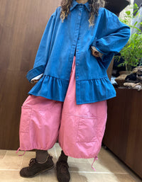 Wide sleeve cuffs with contrasting white inner cuffs on an oversized blue women's shirt.
