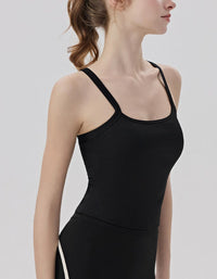 Person wearing a black tank top against a plain background side view