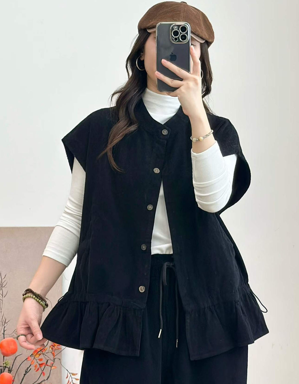 Button front black vest with gathered ruffle hem
