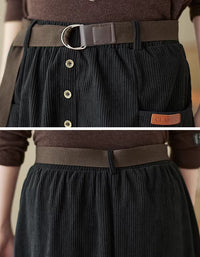 Close-up of women’s black corduroy skirt with belt and button front, highlighting the comfortable, stylish design