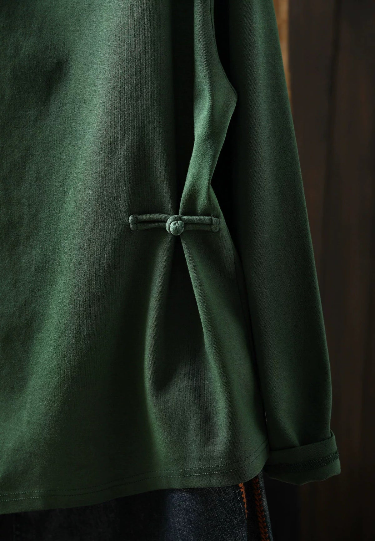 Women's forest green high neck sweater styled on a model in close-up