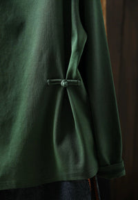 Women's forest green high neck sweater styled on a model in close-up
