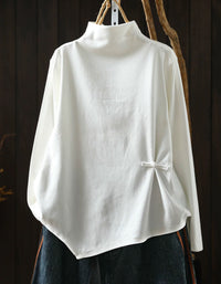 White women's high neck sweater with asymmetrical hem and side button detail