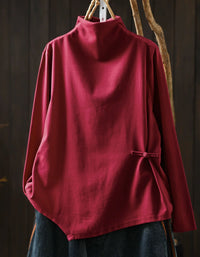 Red women's high neck sweater with asymmetrical hem and side button detail