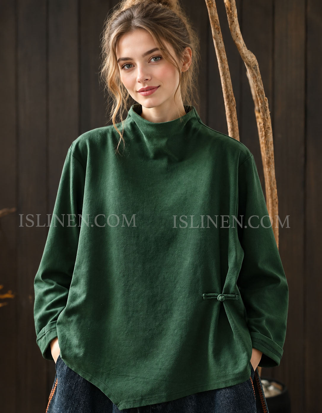 Dark green women's high neck sweater with asymmetrical hem and side button detail