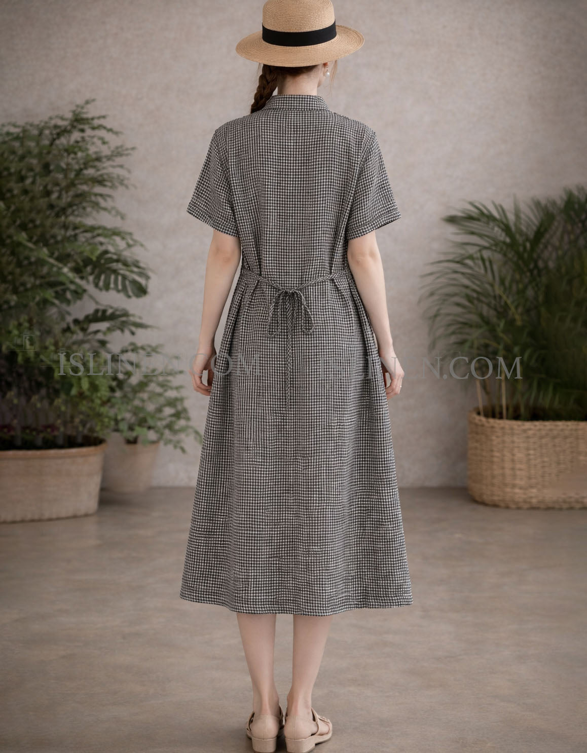 Back view of women’s black gingham linen midi shirt dress showing relaxed fit and straight hemline