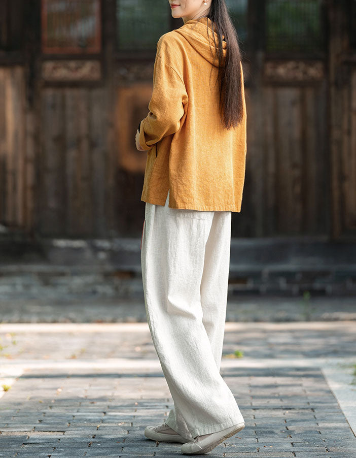 Women wearing breathable yellow linen hoodie top outdoor style back view