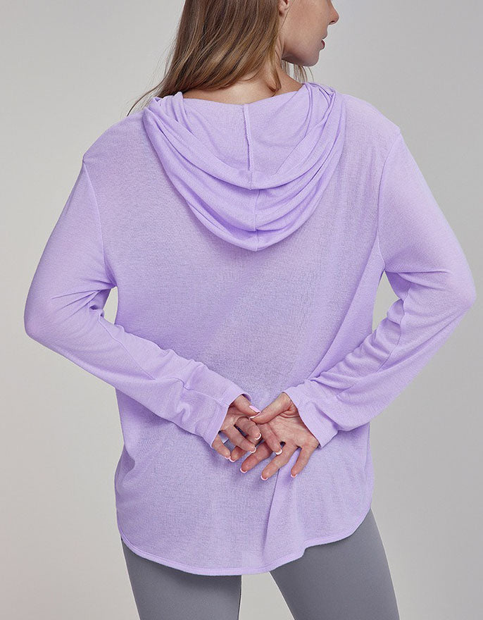 Person wearing a light purple hoodie on a gray background back view