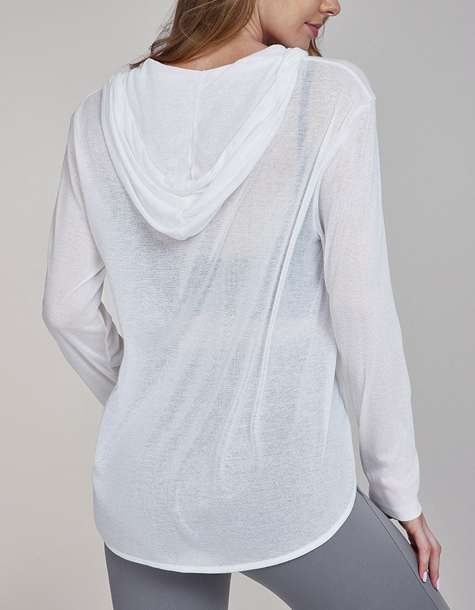 Person wearing a light gray hoodie and gray leggings on a plain background back view