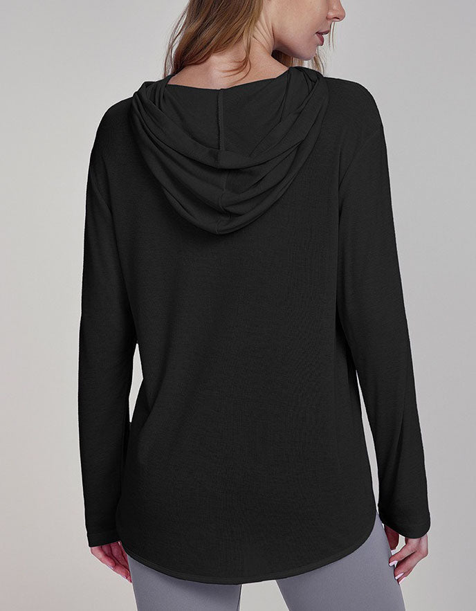 Black long-sleeve top worn by a person on a gray background back view