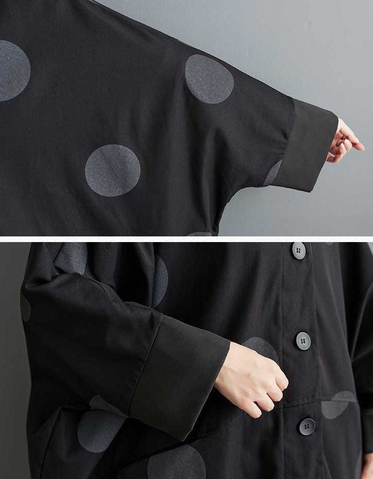 Close up of black polka dot pattern on women’s oversized long coat
