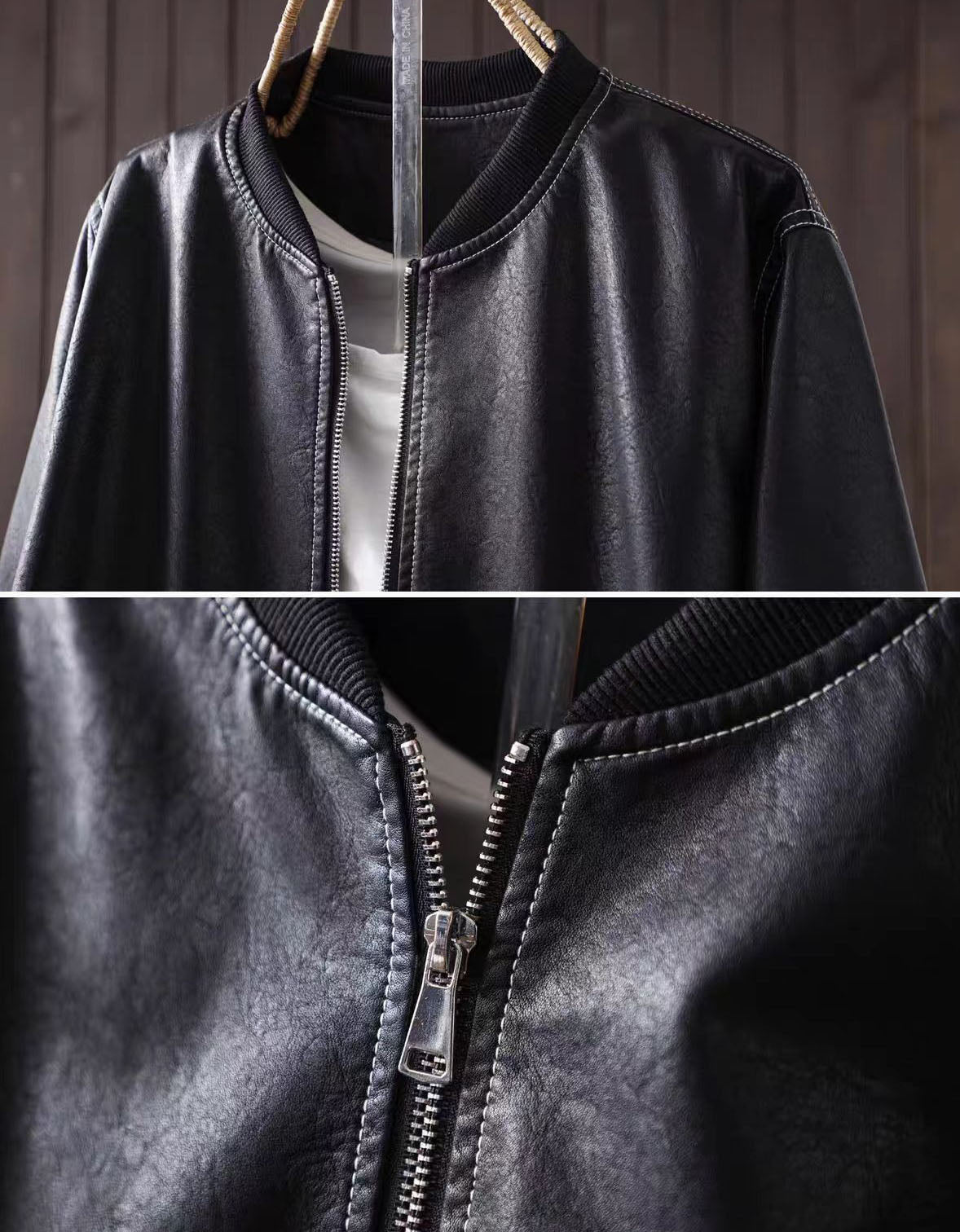 Close-up of the black bomber jacket's ribbed collar, front zipper, and stitched panel details
