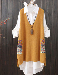 Mustard yellow knitted vest with patterned sleeves over a white shirt on a wooden background