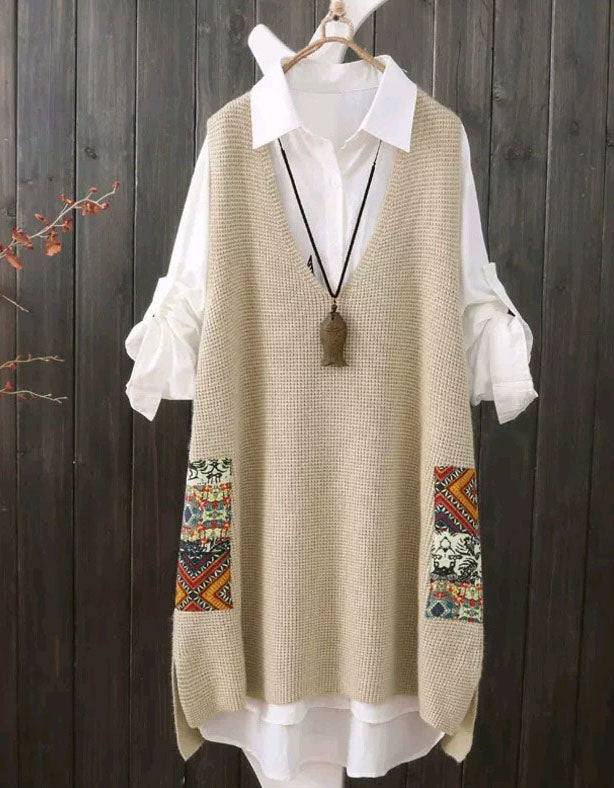 Beige patterned vest over a white shirt on a wooden background