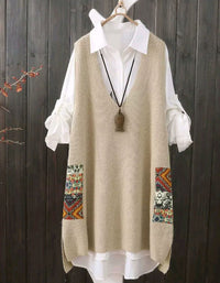 Beige patterned vest over a white shirt on a wooden background