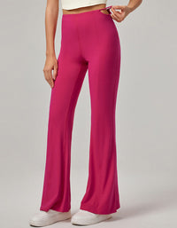 Person wearing bright pink pants on a plain background