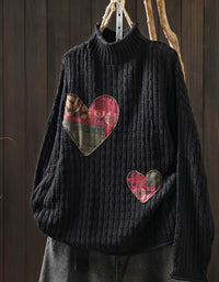 Women's black chunky rib knit sweater with plaid heart patches