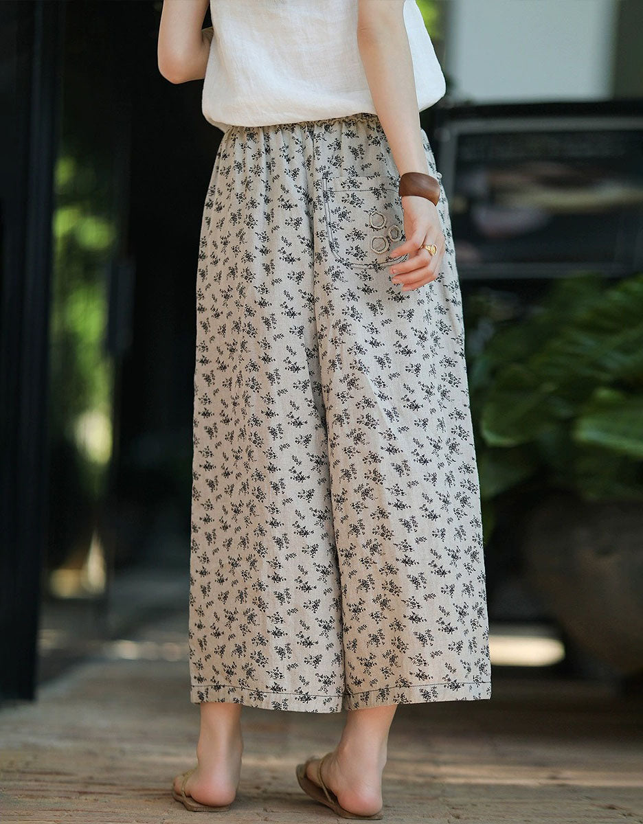 Vintage style floral linen trousers paired with casual sandals back view