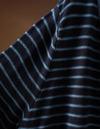 Side view of women's striped knit top with ruched waist detail