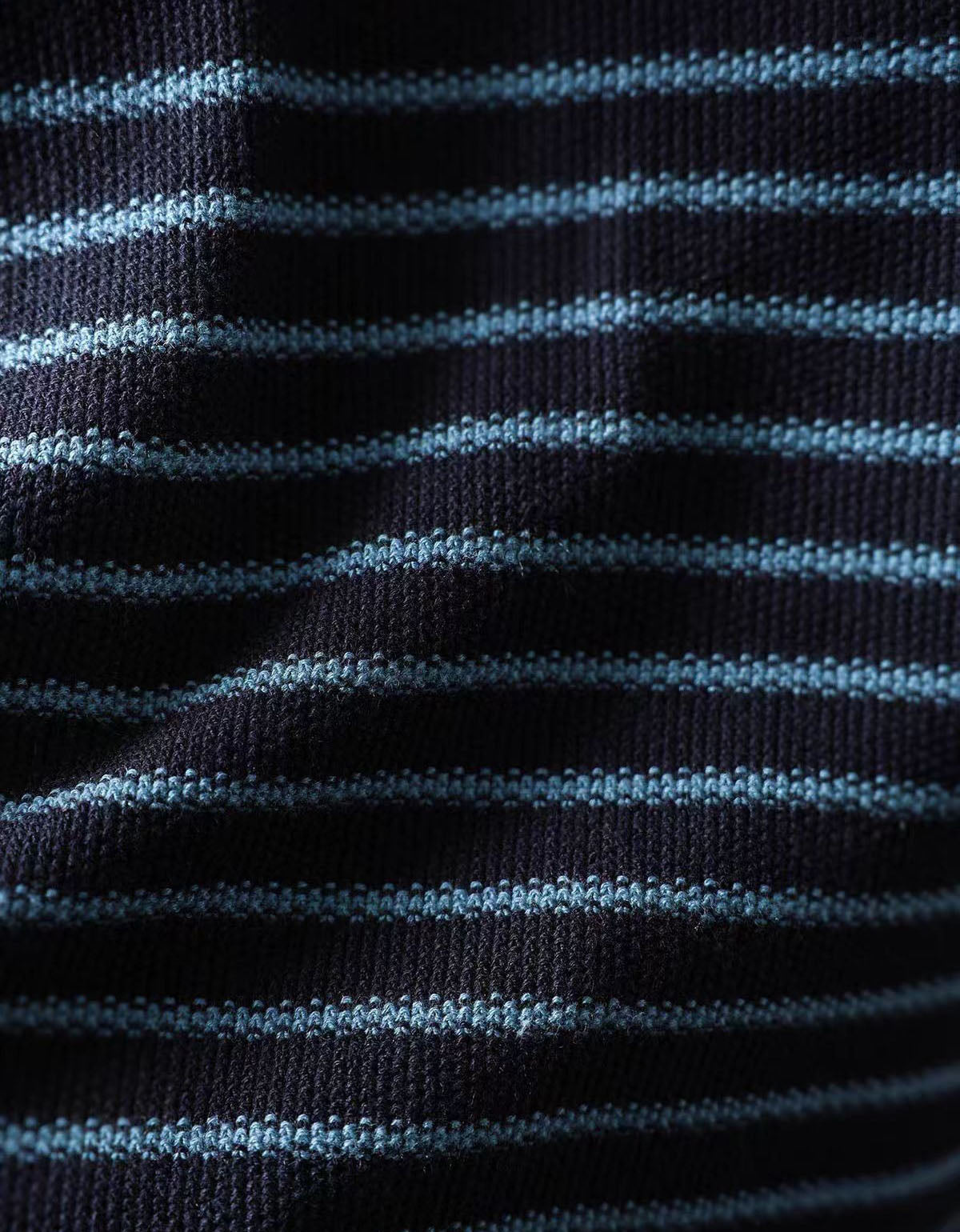 Detail view of women's navy striped relaxed fit knit top