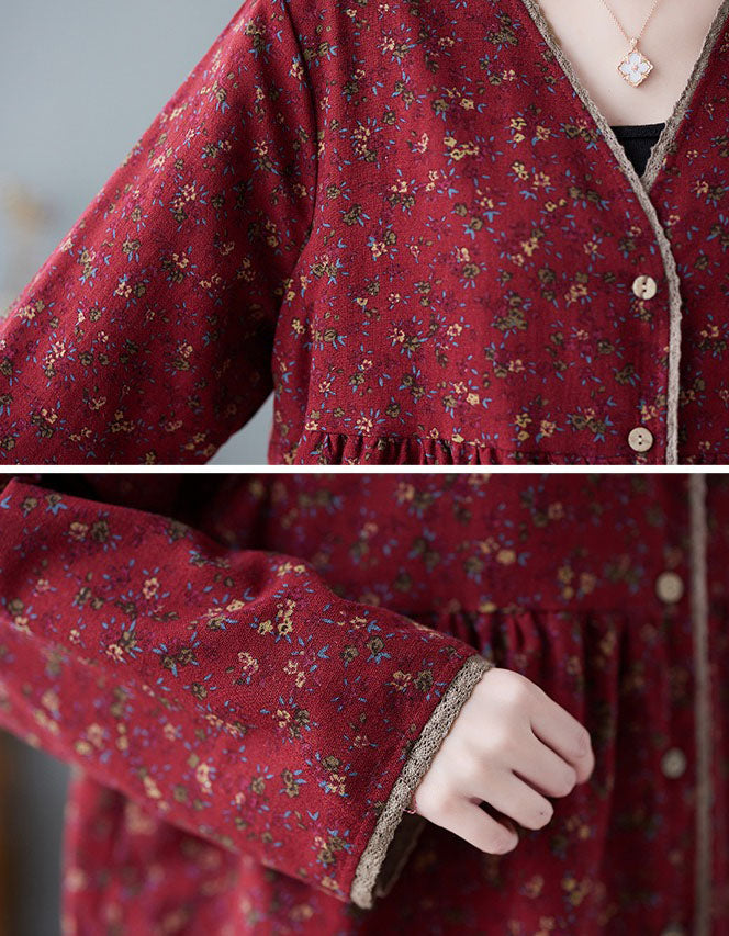 Detailed view of floral pattern on women’s button-up v-neck top in navy blue