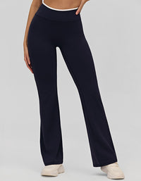 Navy blue yoga pants worn by a person on a light gray background