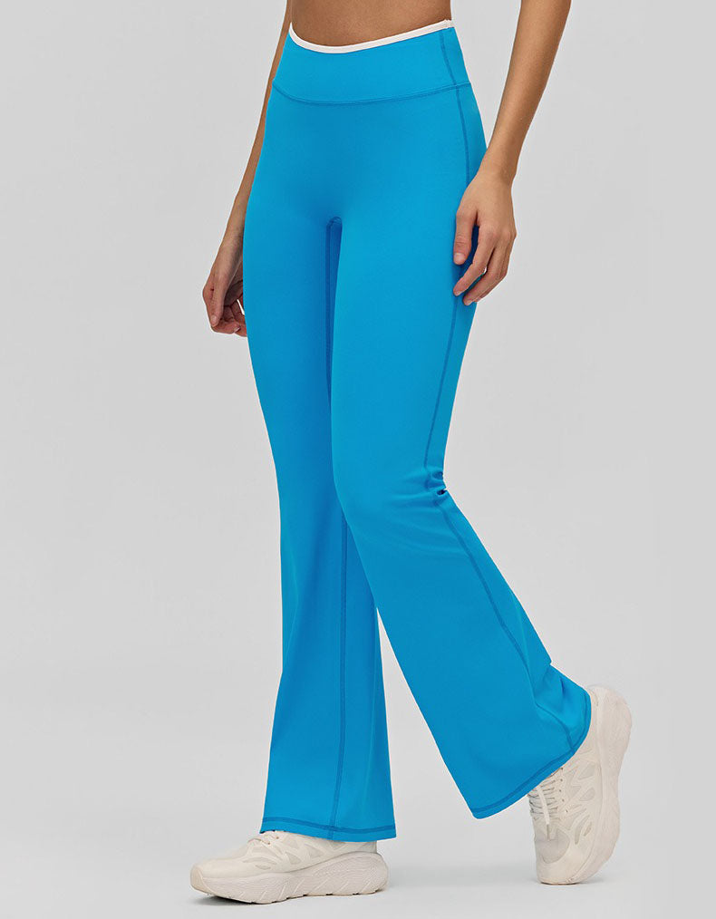 Person wearing bright blue flared pants on a plain background