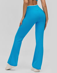 Blue flared pants worn by a person on a gray background back view