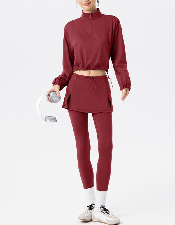 Person wearing a maroon athletic outfit holding a water bottle on a white background