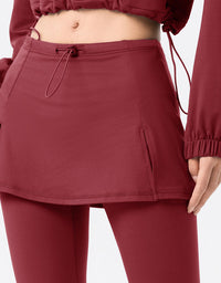 Maroon athletic outfit with skirt and leggings on a white background