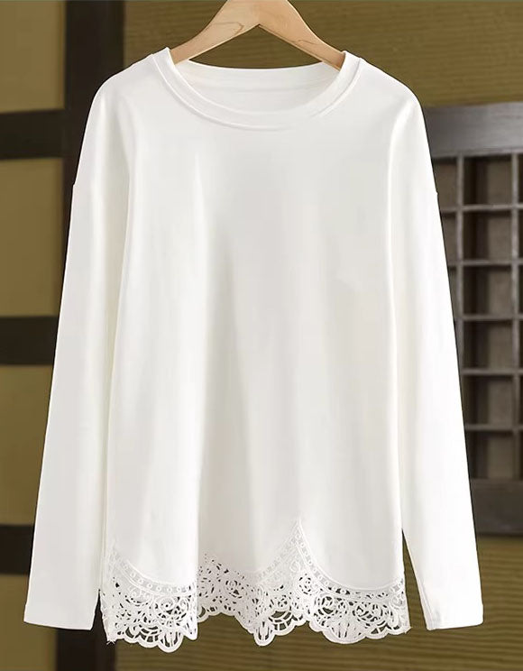 White long-sleeve top with lace hem on a wooden hanger.