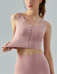 Woman wearing a pink athletic outfit on a gray background