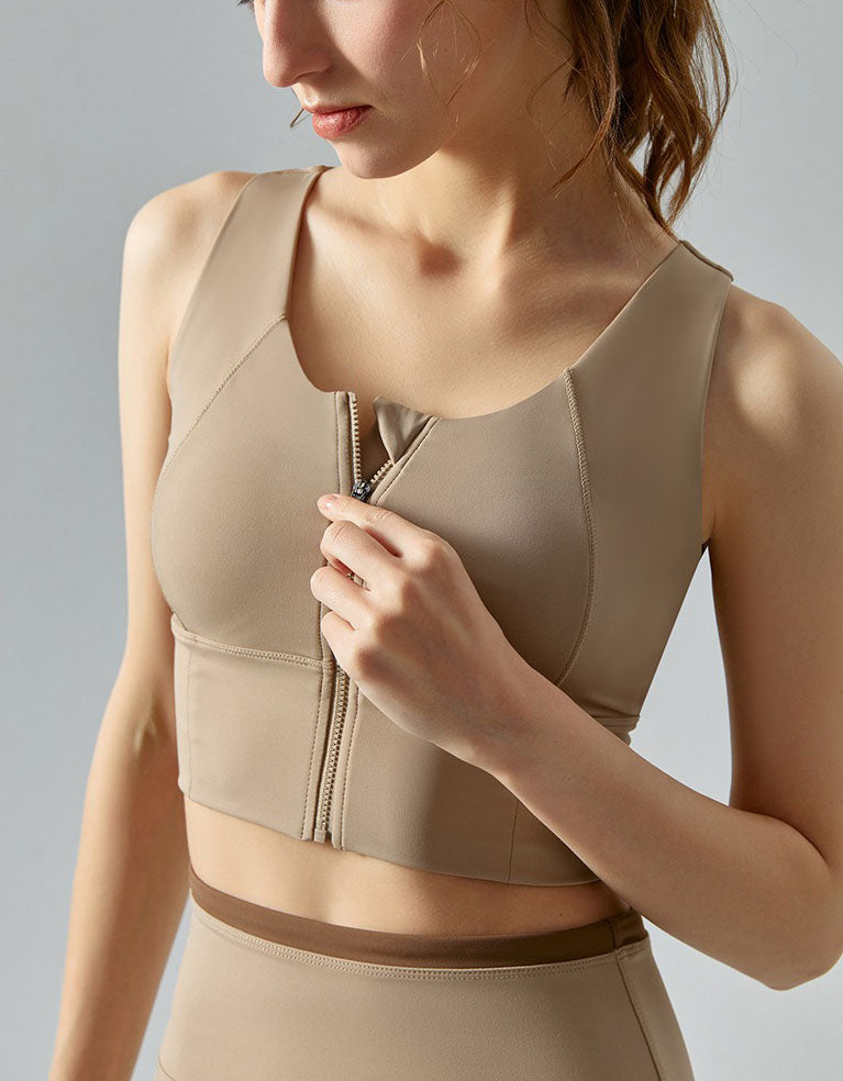 Beige compression garment with a zipper on a neutral background