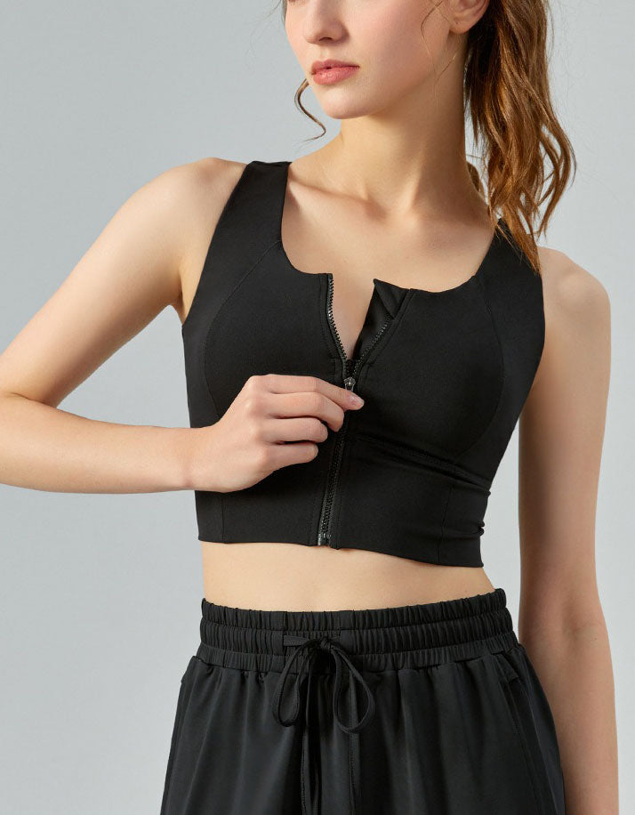 Person wearing a black athletic outfit on a gray background