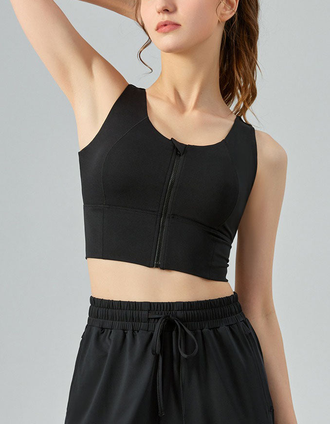 Person wearing a black athletic outfit on a gray background