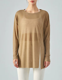 Person wearing a long-sleeve beige top on a plain background