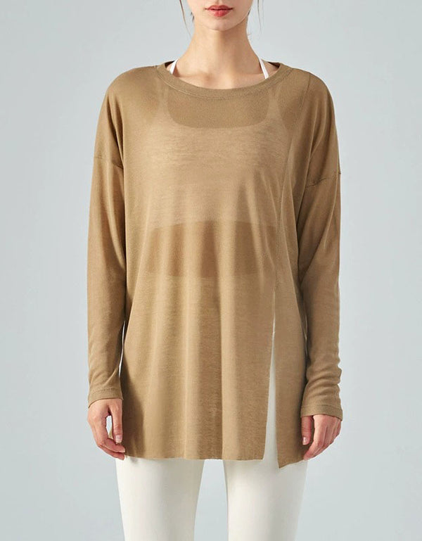 Person wearing a long-sleeve beige top on a plain background