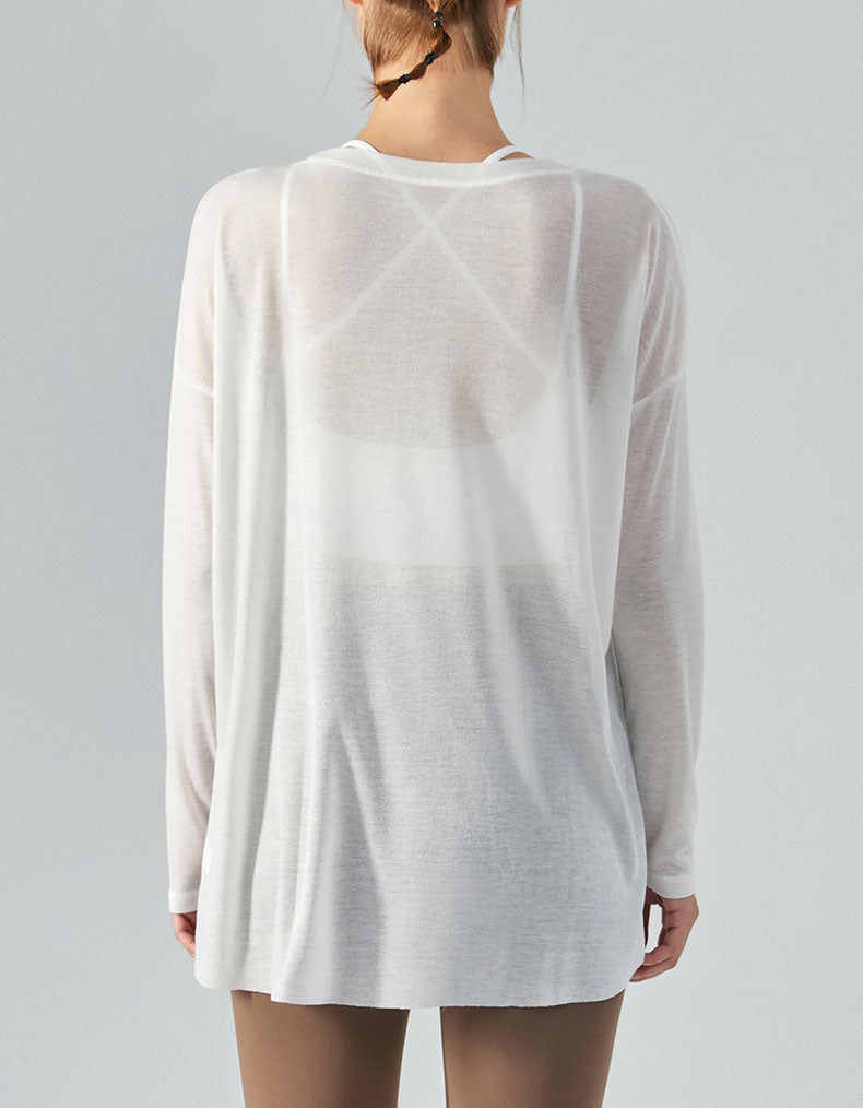 White long-sleeve shirt worn by a person on a gray background back view