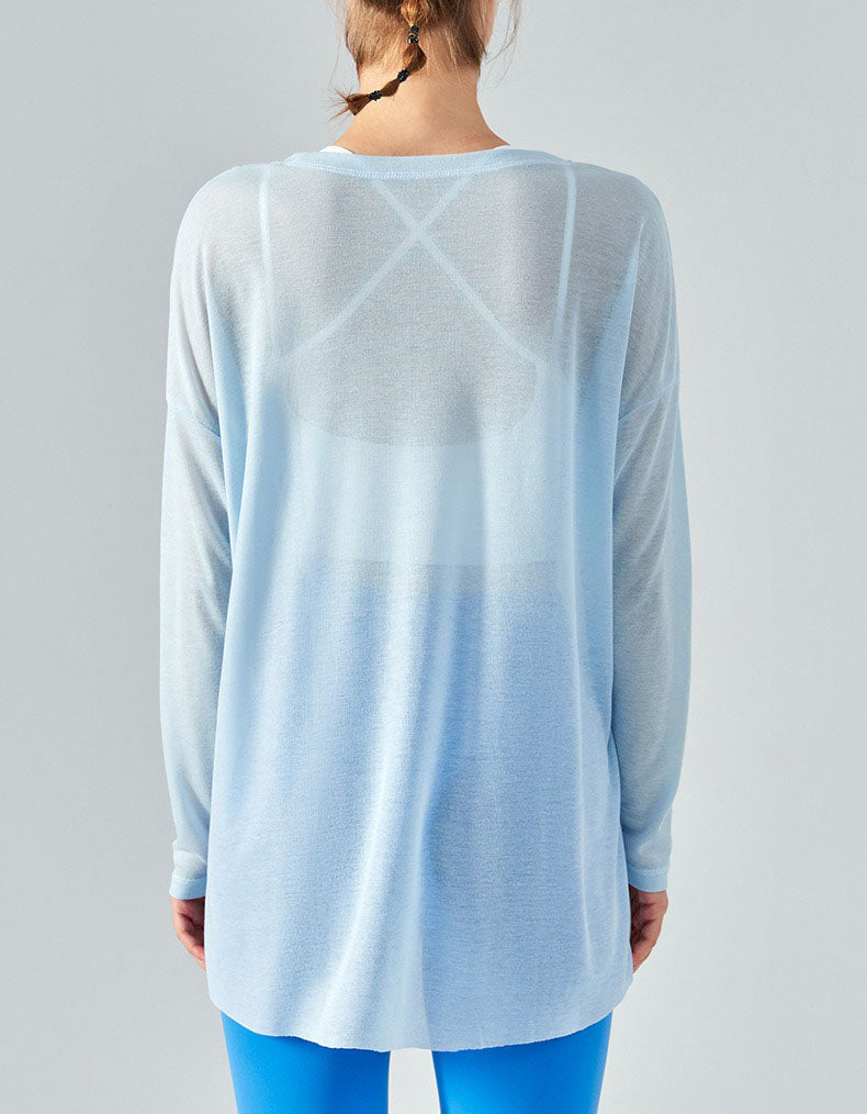 Light blue ombre long-sleeve top worn by a person on a gray background back view