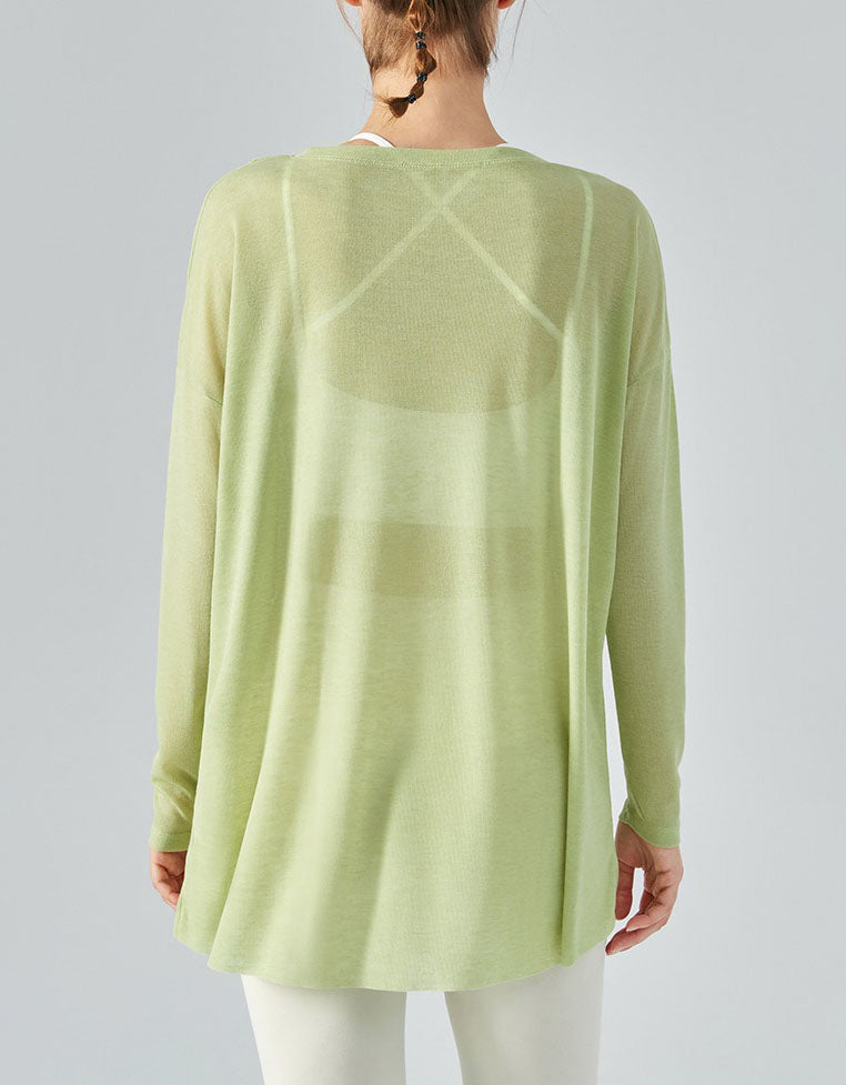 Light green long-sleeve top worn by a person on a plain background back view
