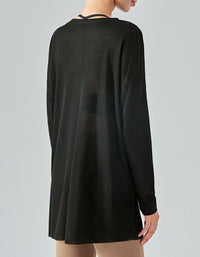 Black long-sleeve dress worn by a person on a gray background back view