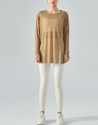 Person wearing a brown long-sleeve top and white leggings on a gray background