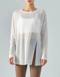 White sheer long-sleeve top worn by a model on a gray background
