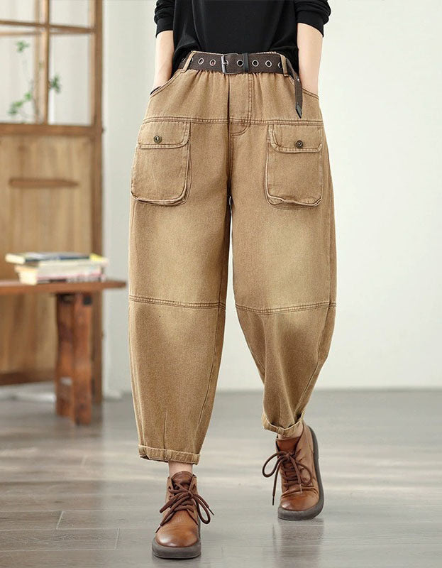 Person wearing brown cargo pants with a belt and brown shoes in a room with wooden furniture.