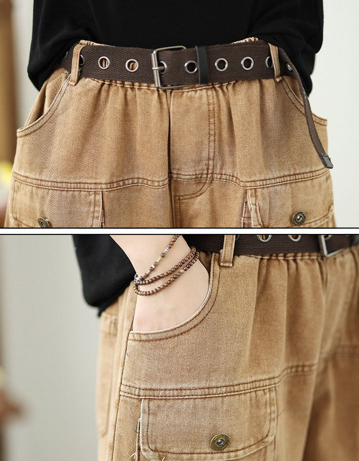 Close-up of khaki denim pants with a belt and a hand wearing a bracelet.