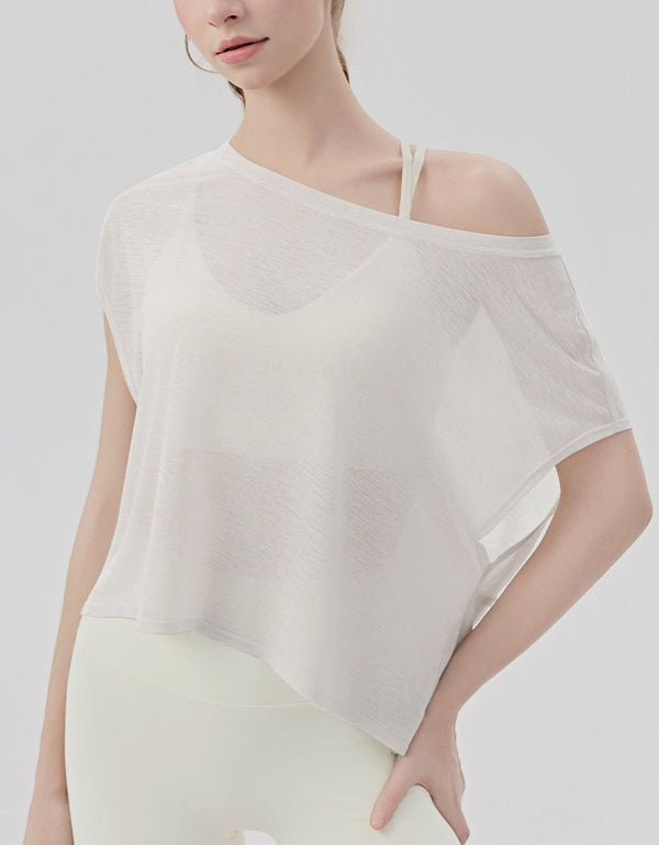 Woman wearing a white off-shoulder top against a light gray background