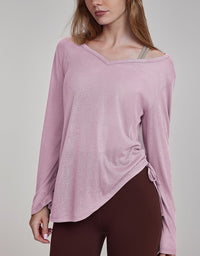 Woman wearing a pink long-sleeve top with a gray background